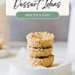 Three quinoa-based dessert cups stacked on a white plate with text reading "Best Quinoa Dessert Ideas: Healthy & Easy" at the top. The background is blurred, highlighting the desserts.