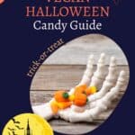 A skeleton hand holding candy corn on a wooden surface, with text "The Ultimate Vegan Halloween Candy Guide" and "trick-or-treat" against a dark background with Halloween-themed graphics.