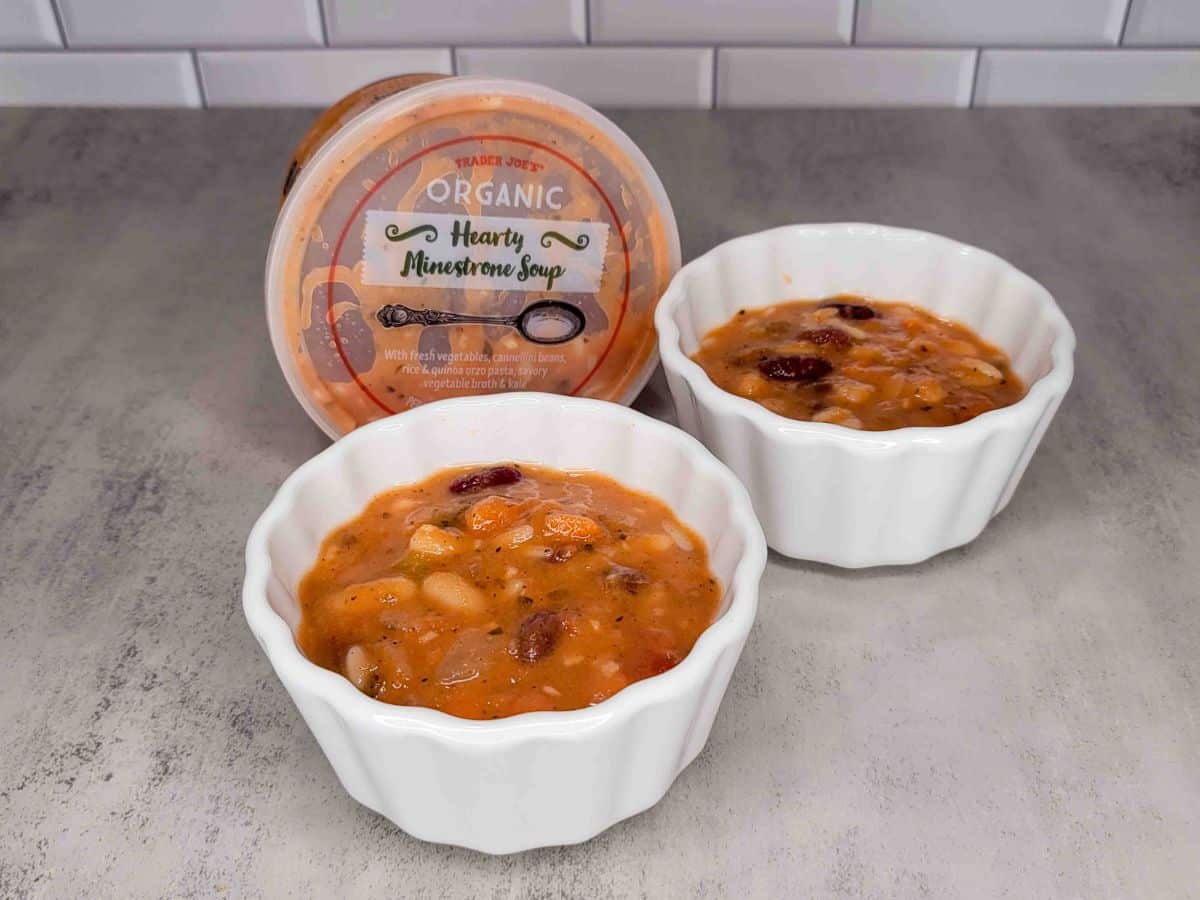 Two bowls of Trader Joe's soup next to each other on a kitchen counter.