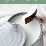 An open can of coconut milk with a spoon holding a piece of coconut above it; text reads “Types of Coconut Milk.”.