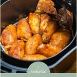 Chicken wings in an air fryer lined with tin foil, accompanied by a text overlay about an air fryer hack using tin foil effectively.
