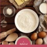 Baking ingredients on a wooden table including flour, butter, milk, eggs, and utensils, with text: "Butter Substitutes for Dairy-Free and Vegan Baking.