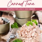 A glass bowl filled with canned tuna, garnished with parsley, placed on a wooden table beside metal bowls and a fork. Text reads: “Easy Ways to Cook with Canned Tuna.”.