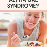 Smiling woman eating a bowl of cereal topped with berries and fruit, with text about what can be eaten with Alpha Gal Syndrome.