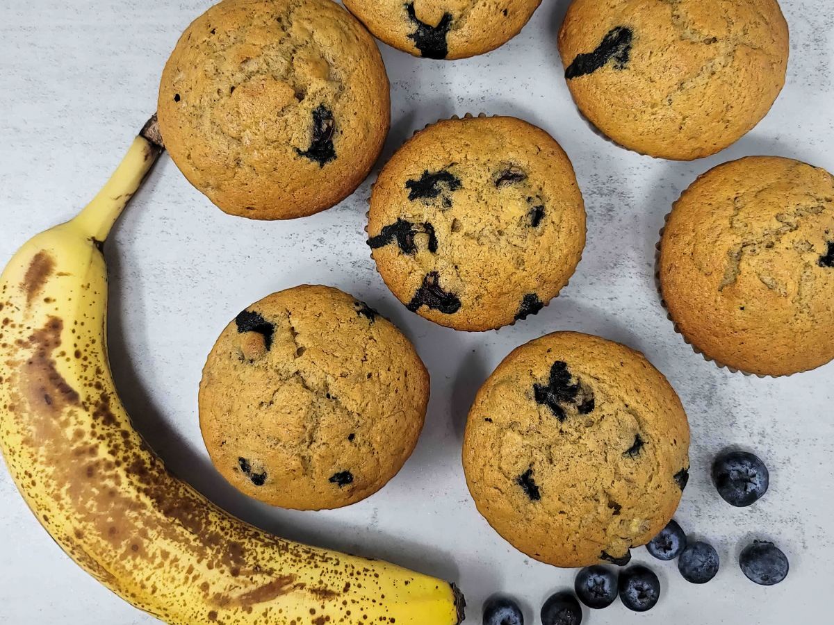 Banana blueberry muffins with an overripe banana and blueberries