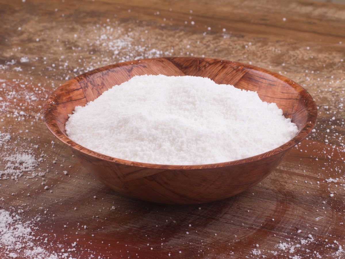 A wooden bowl of tapioca flour on a wooden table.