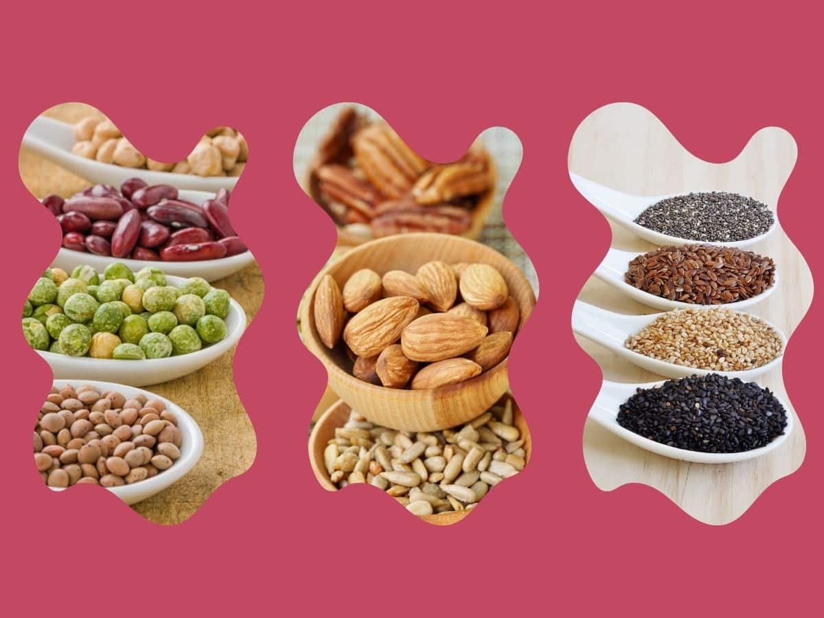 A variety of legumes, nuts, and seeds in bowls on a pink background.