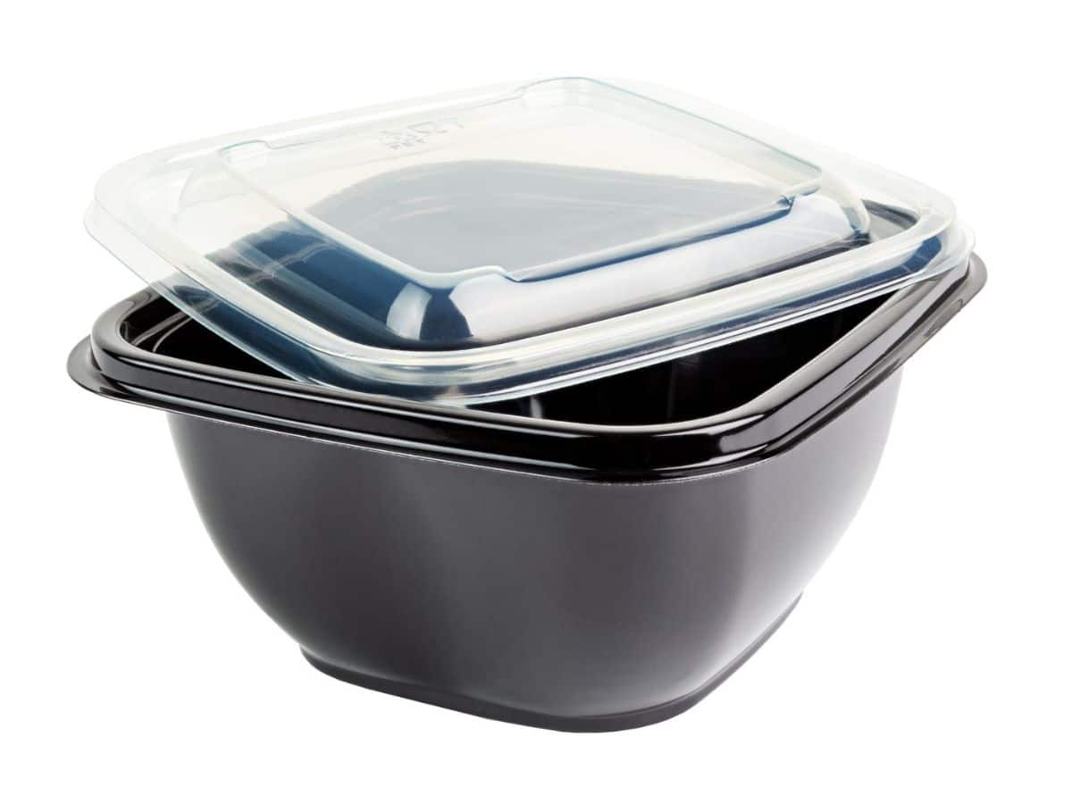 A black plastic take-out container with a lid on it.
