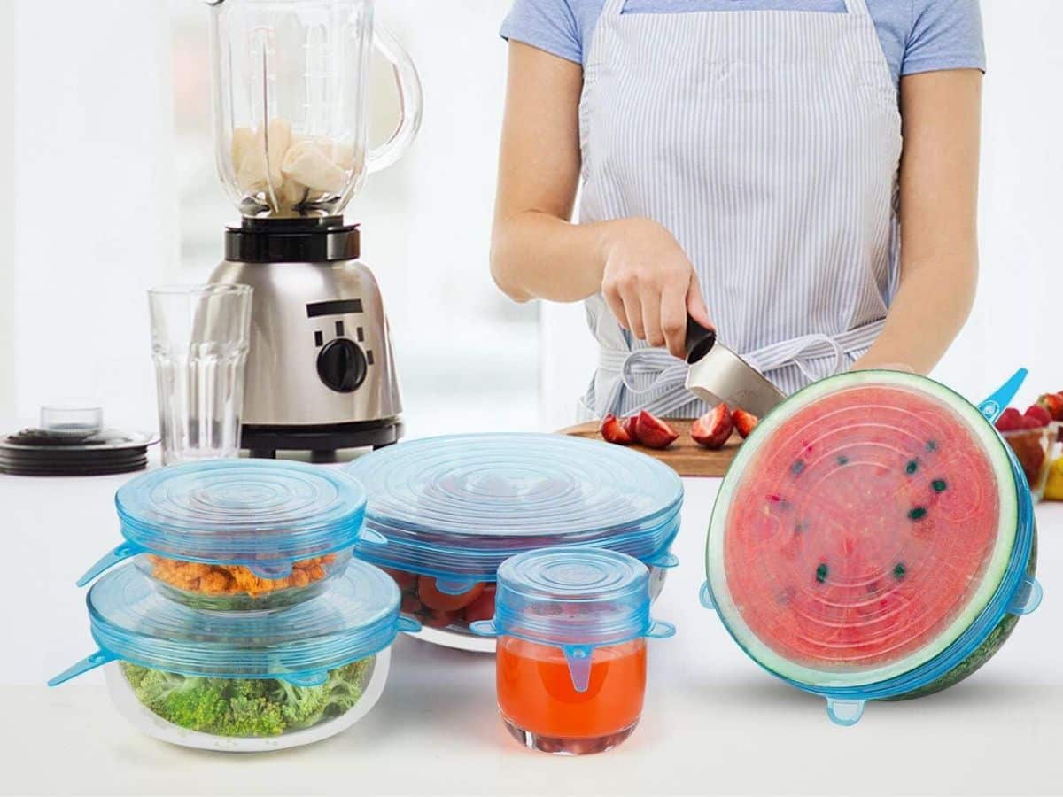 A woman is preparing food in a kitchen with a blender and watermelon.