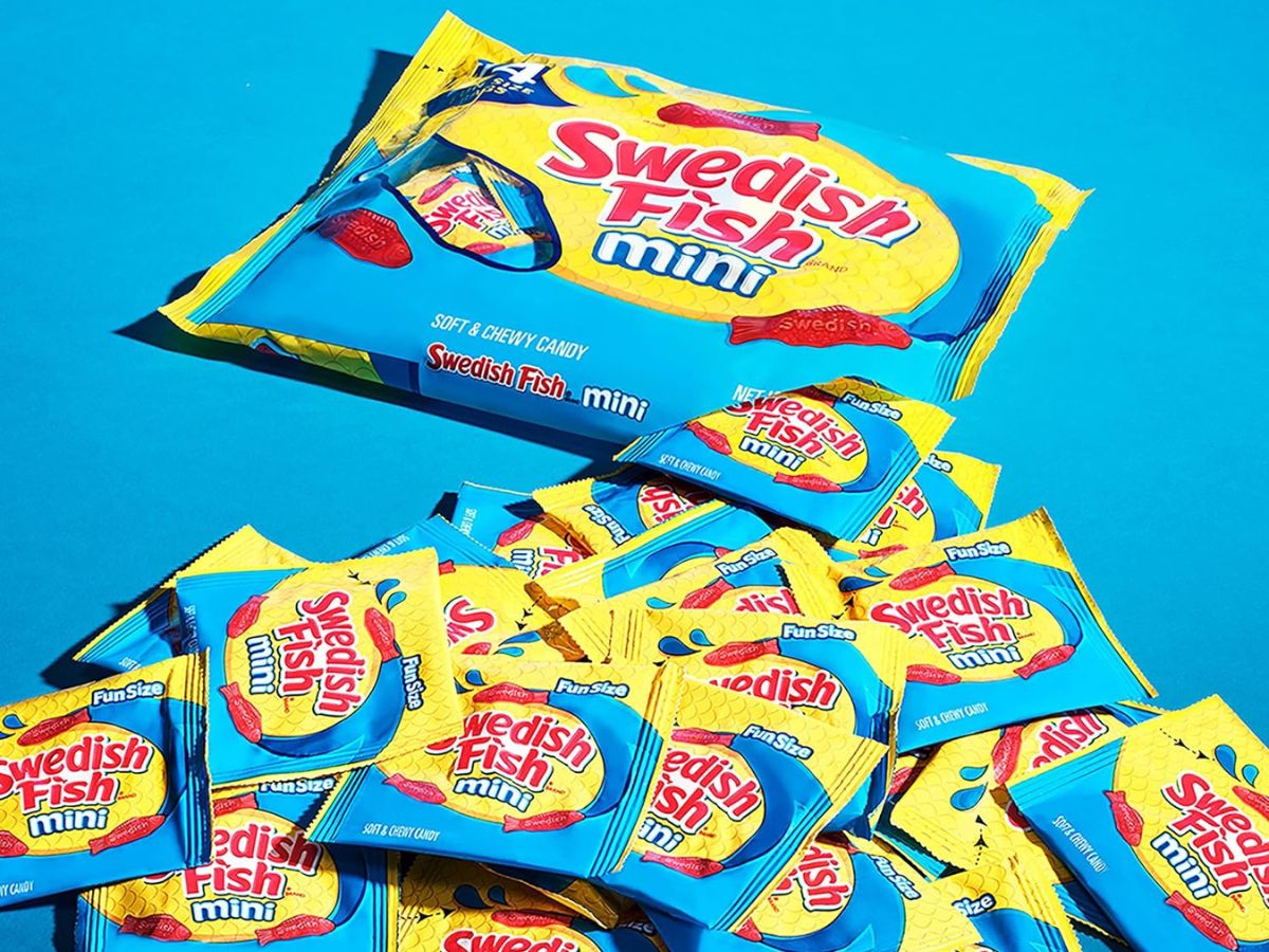 A bag of swedish fish minis on a blue background.