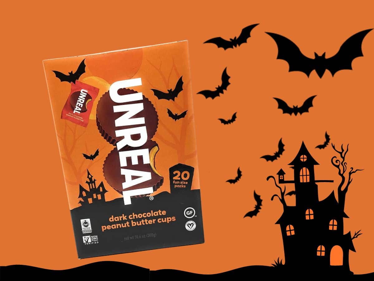 Unreal halloween candy with a house and bats on an orange background.