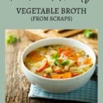 A bowl of vegetable broth with carrots and celery on a wooden surface, accompanied by a blue checkered cloth. Text reads: "Rich and Hearty Vegetable Broth (From Scraps) Sage AlphaGal.