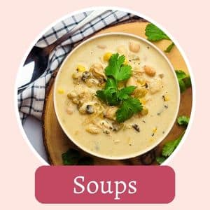 A bowl of creamy soup with beans, corn, and herbs, garnished with cilantro, on a wooden surface with a cloth napkin nearby. The word "Soups" is overlaid in a red text box.