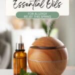 A wooden essential oil diffuser emits vapor next to a small amber dropper bottle and mint leaves on a white surface. Text reads: Best Essential Oils for Allergy Relief This Spring.