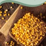 A wooden bowl filled with yellow split peas on a wooden table with scattered peas. The text reads "Why Pea Milk Is Perfect for Vegans" and "Sage AlphaGal.