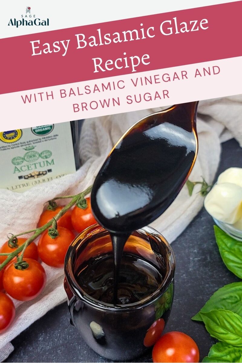 A spoon drizzles thick balsamic glaze over a jar, surrounded by cherry tomatoes, basil leaves, and a bottle of balsamic vinegar.