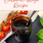 A jar of dark balsamic glaze with a spoon, surrounded by cherry tomatoes, basil leaves, and a white cloth on a dark surface. Text reads: "Two-Ingredient Balsamic Glaze Recipe.