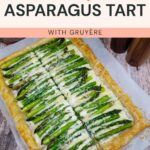 Rectangular asparagus tart with Gruyère cheese, sliced into six pieces on parchment paper, displayed on a wooden surface. Text above reads "Flavorful Asparagus Tart with Gruyère.